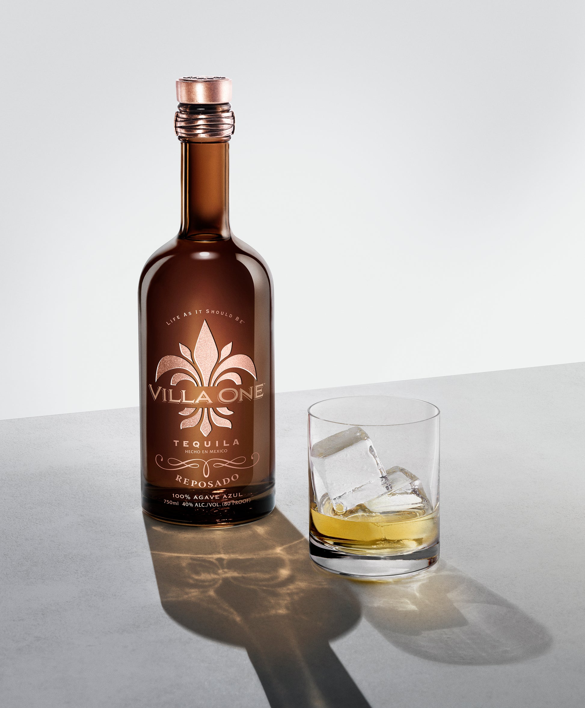 Villa One Tequila Reposado bottle next to a cocktail glass
